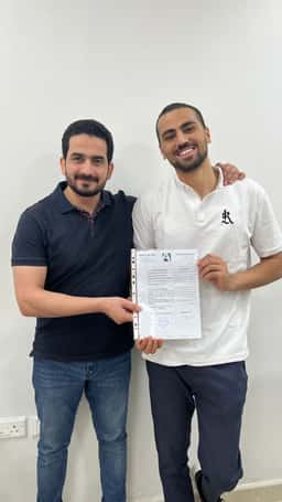 Abdelrahman receiving the AFAQY experience certificate with a team member in Riyadh